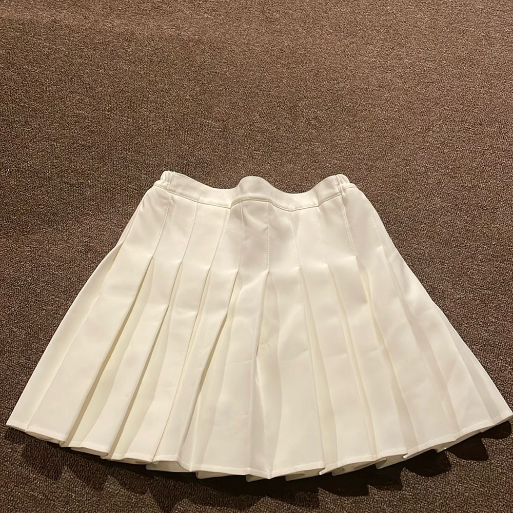 Cream pleated skort by GuanGuanYa.KID - no size listed, estimating a youth XL.